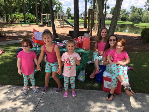 6 Kids at stand posing for picture